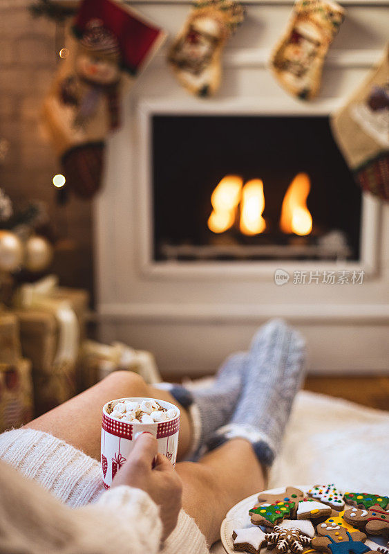 Young beautiful woman drinking hot chocolate in a cozy Christmas atmosphere